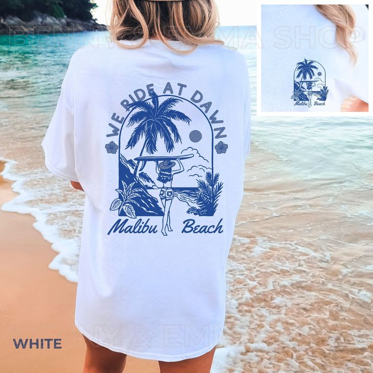 Get ready to be OBSESSED with your We Ride At Dawn Coastal Cowgirl Crewneck Shirt! It's the cutest and most trendy way to emit all those important Coastal Cowgirl and Coconut Girl vibes! This is the perfect Trendy Beachy Summer Shirt! Great as a  gift for all the Beach loving country girlies! * Q U I C K * F A C T S * ✺ 100% preshrunk cotton ✺ Wash and dry normally (on cool for best results) * S I Z I N G * ✺ Models are wearing size XL ✺ Sizing is unisex so runs like men's, though not overly lar Printed White Tops For Surfing, White Short Sleeve Surfing Shirt, White Screen Print Tops For Vacation, White Shirt For Beach Party, White Screen Print Top For Vacation, White Short Sleeve Shirt For Beach Party, White Shirt For Beach Party Season, White Summer Shirt For Beach Party, White Beach Party Shirt