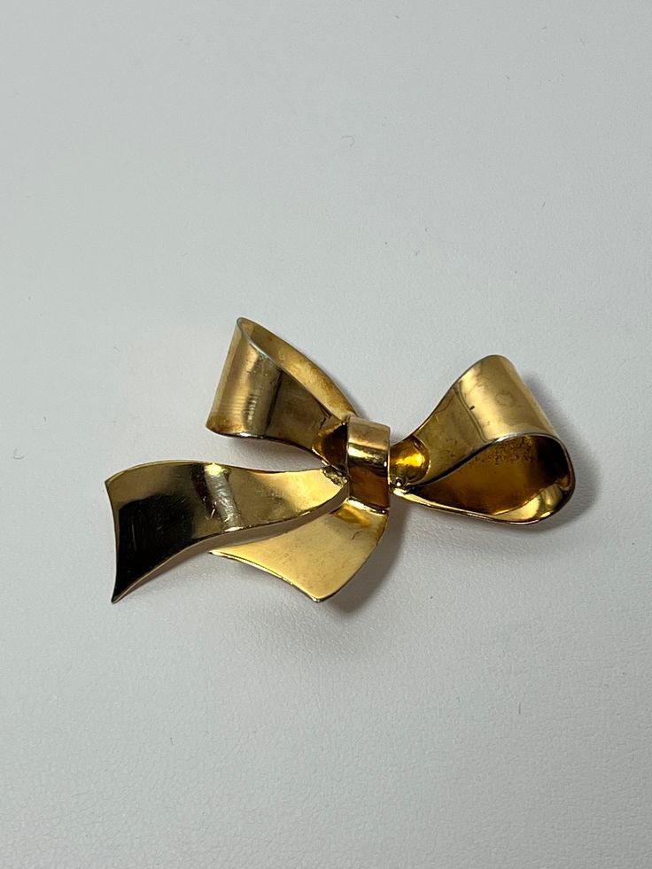 "A vintage Coro sterling silver (stamped \"Coro Sterling\") gold plated bow brooch weighing 7.5 grams featuring a locking C style clasp." Yellow Gold Bow Jewelry For Formal Occasions, Formal 14k Gold Jewelry With Bow Detail, Vintage Jewelry With Decorative Bow As Gift, Heirloom Gold Brooch For Formal Occasions, Mid-century Yellow Gold Brooch For Gifts, Heirloom Gold Brooches For Formal Occasion, Vintage Wedding Brooch With Bow Detail, Mid-century Yellow Gold Brooch Jewelry, Vintage Wedding Brooch With Bow