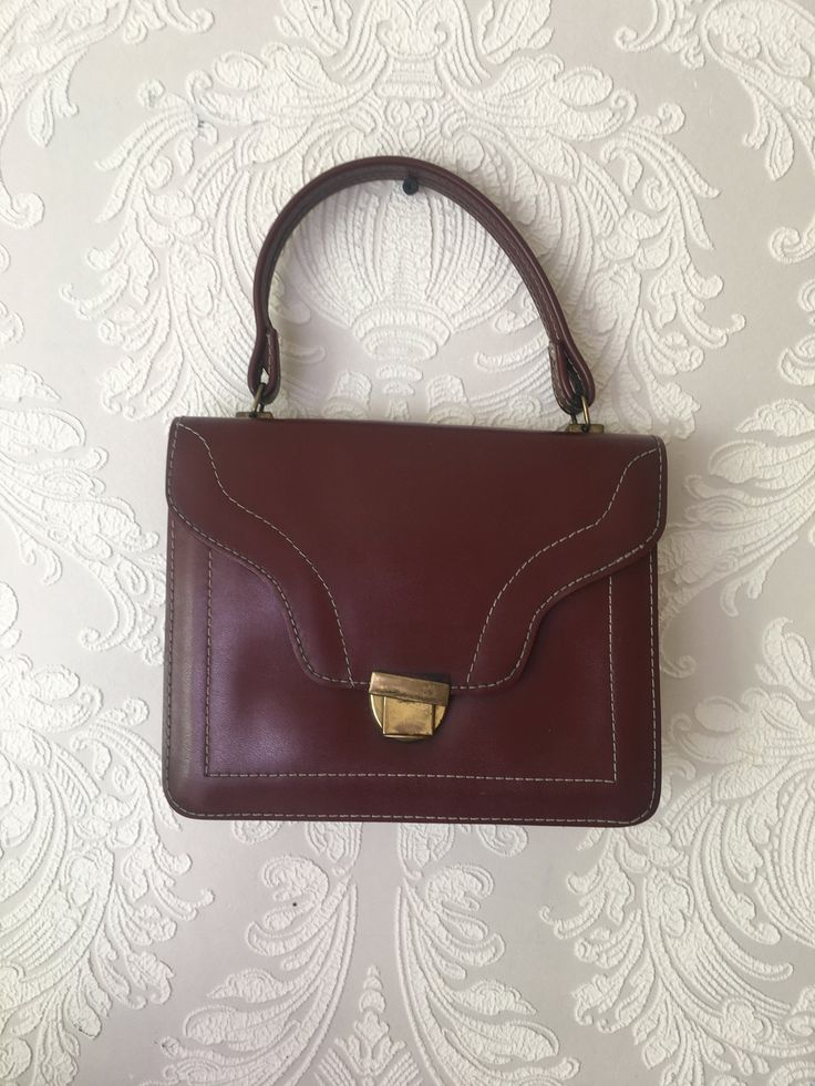 "Vintage cognac brown vegan leather handbag. Classic retro 70s design bag with golden tone closure. Accessories european quality. Women detective style purse. Inside red textile lining and 2 open way pockets. condition: normal condition. The closure is shabby. The closure works well. The red lining has some spots. measurements: width 24 cm / 9.4\" in height without handle 19 cm / 7.4\" in handle length 33 cm / 13\" in" Women Detective, Red Textiles, 70s Design, 70s Women, Brown Leather Crossbody Bag, Design Bag, Top Handle Bags, Brown Handbag, Crossbody Bag Women