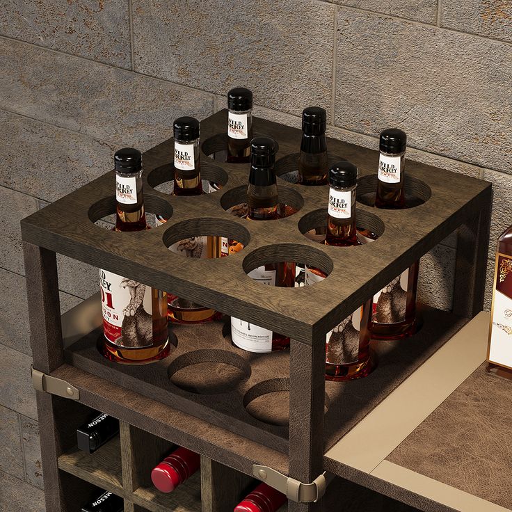 a wooden shelf with bottles on top of it next to a box of whiskeys