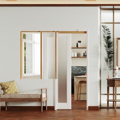 a living room with white walls and wooden floors