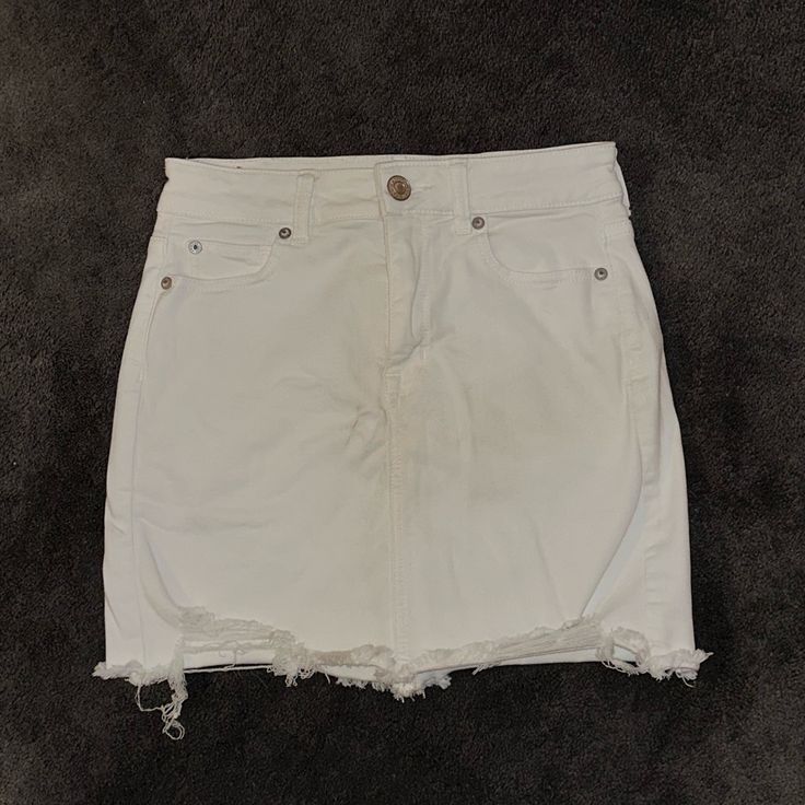 Size 2long; American Eagle; Distressed; White; Fits Like A 4 Sits Above Knee, I’m 5’7 For Reference; Never Worn White Jean Skirt, American Eagle Skirt, Denim Button Skirt, White Fits, Black Jean Skirt, Stretch Denim Skirt, Distressed Jean Skirt, Blue Jean Skirt, White Denim Skirt