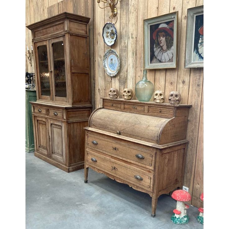 an old fashioned dresser and armoire are on display