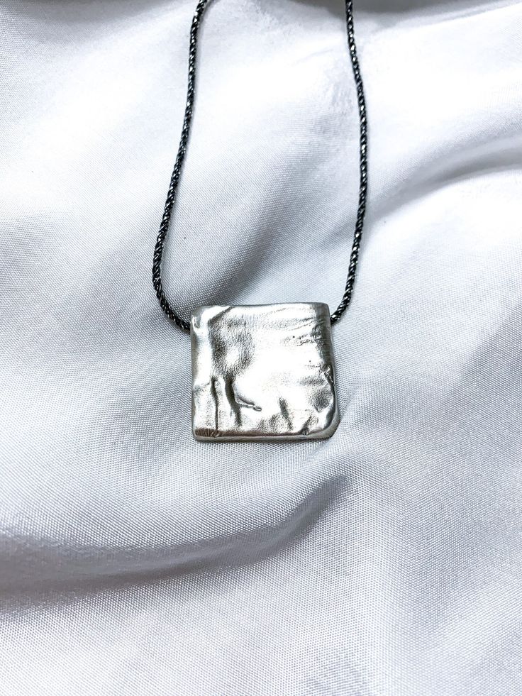 "Ashley - Handmade Square locket pendant This one-of-a-kind pendant was created using the lost wax casting technique. It was first handcrafted from wax and then cast in silver, resulting in a truly unique piece. Designed to bring a fresh and stylish touch to both everyday wear and special occasions, this pendant embodies perfection in silver, adding a touch of elegance to any necklace. ✤ DETAILS ✤ * Material: 925 Silver * 100% Hypoallergenic & Tarnish Resistant, no green skin! ✤ HOW TO ORDER ✤ *Choose your desired length from the dropdown menu, then click \"\"Add to Cart\"\" and proceed to checkout. ➢ MORE NECKLACE: https://www.etsy.com/shop/NiahJewelryDesign?ref=shop-header-name&listing_id=1361449260&section_id=37996777 ➢ BACK TO MY SHOP: https://www.etsy.com/il-en/shop/NiahJewelryDesign Minimalist Handmade Necklace For Keepsake, Artisan Necklace With Rectangular Pendant As A Gift, Oxidized Pendant Necklace For Gift, Hand Cast Round Pendant Jewelry For Gift, Artisan Rectangular Pendant Necklace As A Gift, Hand-cast Round Pendant Jewelry Gift, Artisan Style Rectangular Pendant Necklace As Gift, Oxidized Finish Pendant Necklace For Gift, Handmade Amulet Necklace For Everyday Wear