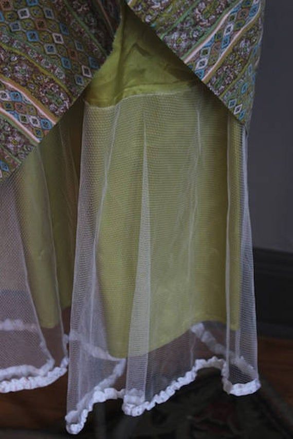 "50s inspired super cute midi dress in lovely shades of moss green, light blue and peach. Nice attached netted crinoline for a full circle skirt with lacey white trim exposed at the hem. Fully lined in chartreuse satin. Excellent condition. Side zipper and front buttons covered in matching fabric. Fits the following measurements: Bust up to 36\" Waist 28\" Hips free Length from nape of neck to hem is 38\"" Green Organza Dress For Garden Party, Green Organza Summer Dress, Spring Green Organza Dress, Green Organza Dress For Spring, Sheer Long Skirt Summer Dress, Sheer Long Summer Dresses, Green Sheer Tulle Dress, Green Sheer Dress For Wedding, Green Tulle Skirt Dress For Summer