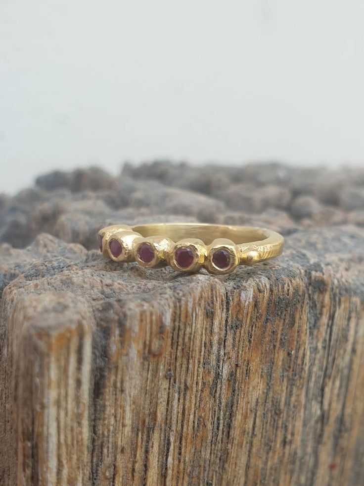 Gold Five stone dainty band ring. Gold July ruby ring. Five rubies Round Ring, Classic ring. Great gift. handmade. anniversary, valentine This is a goldfilled ring. Its a five stone ring, A delicate designer handmade ring which has a raw design. The ring is set with 5 rubies stones. You can choose you're favorite gemstone or birthstone from: blue topaz, citrine, moonstone, garnet and smoky quartz. This ring can be also be one of a stacking casual ring set. This ring is made with high quality 14k Ruby Stackable Rings With Birthstones, Stackable Ruby Birthstone Rings With Round Band, Stackable Ruby Birthstone Rings, Ruby Birthstone Ring With Bezel Setting, Dainty Ruby Gemstone Stackable Rings, Gold Stackable Rings With Ruby Bezel Setting, Ruby Stackable Round Band Promise Rings, Ruby Ring With Rose Cut Diamonds For Promise, Gold Stackable Ruby Ring