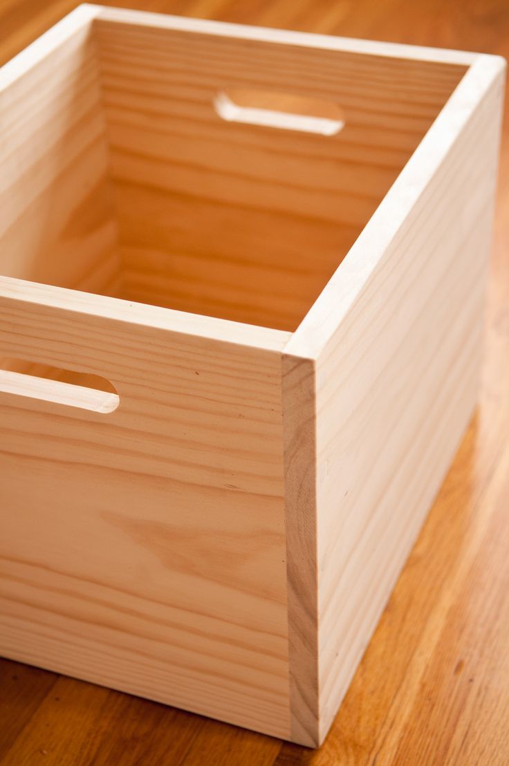 a wooden box sitting on top of a hard wood floor