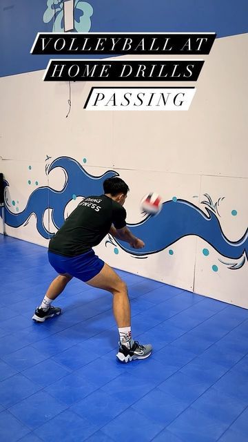 a man in black shirt and blue shorts playing with a frisbee at volleyball