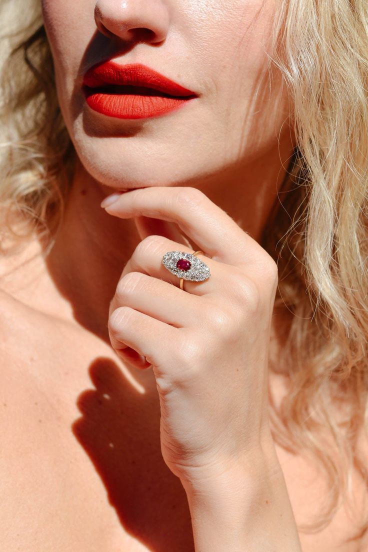 This antique Edwardian ruby and diamond ring circa 1915 combines the glow of a natural untreated Burmese ruby with the sparkle of old mine cut diamonds in one pleasing design. At the heart of this ring gleams a GIA certified cushion cut natural untreated Burmese ruby, approximately .56 carats in weight. This precious gemstone possesses a vivid red hue and remains untreated, allowing its natural beauty to shine through. The ruby is set amidst a navette shaped cluster of variously sized old mine c Antique Ruby Ring With Single Cut Diamonds, Antique Ruby Rings With Single Cut Diamonds, Fine Jewelry Ruby Cluster Ring With Rose Cut Diamonds, Marquise Ruby Ring With Rose Cut Diamonds, Luxury Oval Rings With Rose Cut Diamonds And Ruby, Oval Lab-created Ruby Rings With Rose Cut Diamonds, Oval Rose Cut Diamond Ring With Ruby Accents, Vintage Ruby Rings With Single Cut Diamonds, Heirloom Style Brilliant Cut Ruby Ring