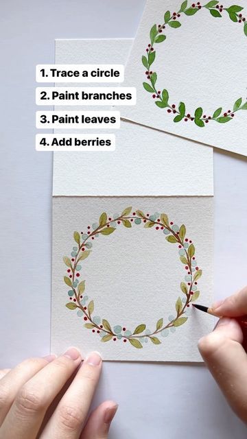 someone is painting a wreath on some paper