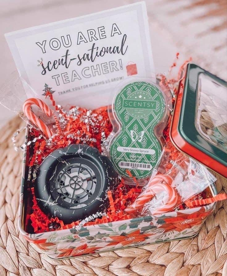 a gift box filled with candy canes, candies and other holiday treats for teachers