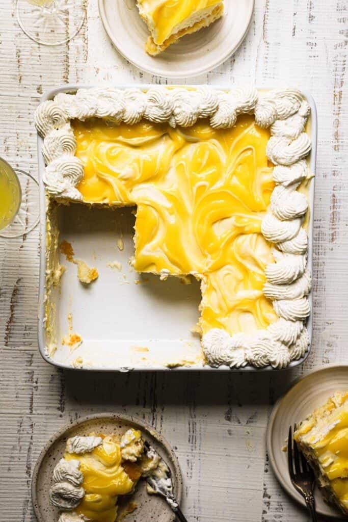 a piece of cake on a plate with a fork next to it and another slice missing