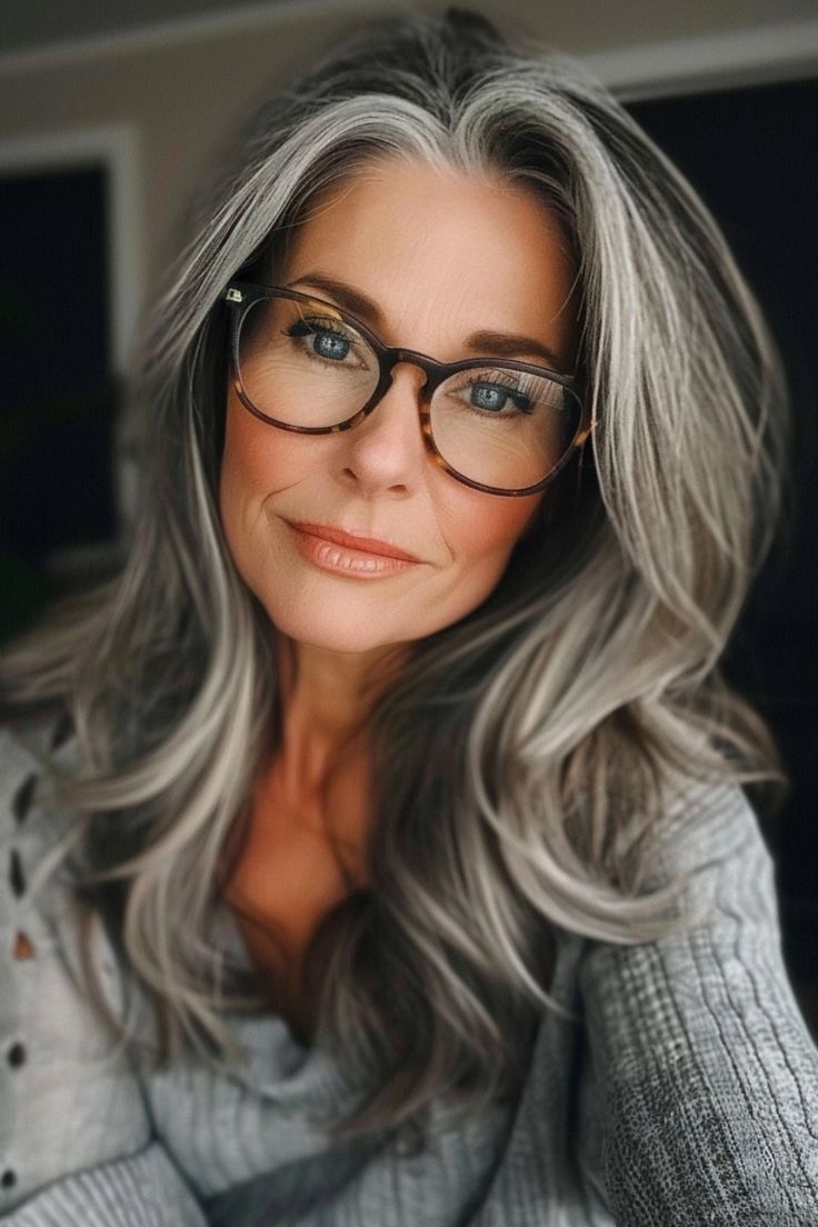 Woman with long gray hair and glasses smiling at the camera. Long Hair Older Women, Hair And Glasses, Grey Blending, Grey Hair Transformation, Gorgeous Gray Hair, Grey Hair Inspiration, Beautiful Gray Hair, Blending Gray Hair, Long Gray Hair