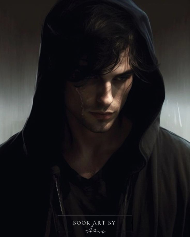 a man wearing a hoodie in the dark