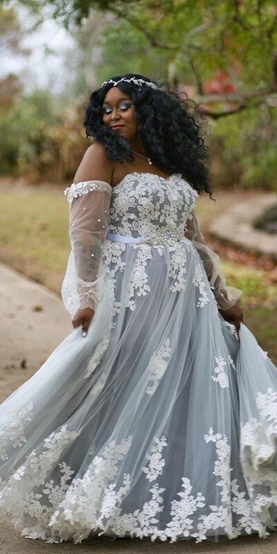 a woman in a wedding dress is walking down the street with her hand on her hip