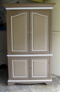 an armoire with two doors on the front and one door open, in a garage