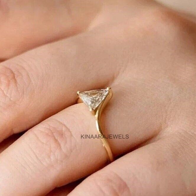 Triangle Moissanite Ring * Triangle Diamond Ring * Solid Gold * Dainty Diamond Ring ● 𝐃𝐢𝐚𝐦𝐨𝐧𝐝 𝐃𝐞𝐭𝐚𝐢𝐥𝐬 > Stone type: Moissanite / Simulated Diamond > Center Stone Shape: Triangle Cut > Weight: 1.00 CT > Stone Color: Colorless > Main Stone Clarity: VVS1 > Cut Grade: Excellent ❤ More Of My Engagement Ring ❤  https://www.etsy.com/shop/kinaarajewels ●  Kinaarajewels Services/Notes  A. Handmade Customized Jewelry. B. More than 50+ Antique and Fancy Cuts and Shapes of Moissanite Diamonds. Ring With Triangle Stone, Triangle Ring Engagement, Triangle Stone Ring, Diamond Ring With Vs Clarity And Trillion Cut, Trillion Cut Diamond Ring With Prong Setting As Gift, Trillion Cut Diamond Ring Vs Clarity, Gold Trillion Cut Solitaire Jewelry, Gold Solitaire Jewelry With Trillion Cut, Trillion Cut Moissanite Rings For Gift