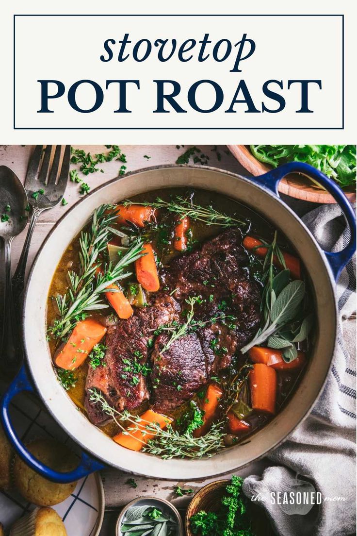 pot roast with carrots, potatoes and herbs in a white bowl on top of a table