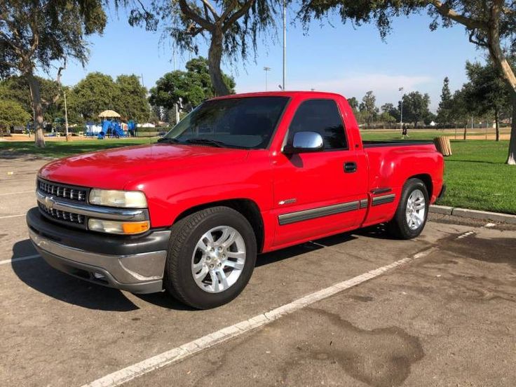 a red pick up truck parked in a parking lot