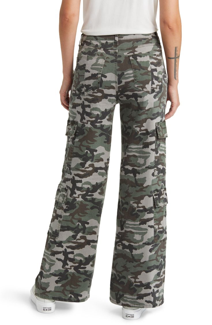 Give in to your style nostalgia and throw it back to Y2K in a pair of wide-leg cargo pants cut from a stretchy cotton blend patterned with classic camo. 32" inseam; 25 1/2" leg opening; 10" front rise; 15" back rise 97% cotton, 3% spandex Machine wash, tumble dry Imported Military Camouflage Jeans With Cargo Pockets, Military Cargo Style Camouflage Jeans, Military Camouflage Cargo Jeans, Camouflage Military Cargo Jeans, Camouflage Wide Leg Cargo Bottoms, Military Style Wide Leg Cotton Cargo Pants, Camouflage Wide Leg Bottoms With Multiple Pockets, Wide Leg Camouflage Bottoms With Multiple Pockets, Camouflage Wide-leg Bottoms With Multiple Pockets