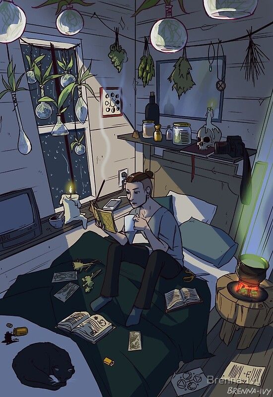 a man sitting on a couch in a room with plants hanging from the ceiling and other items scattered around