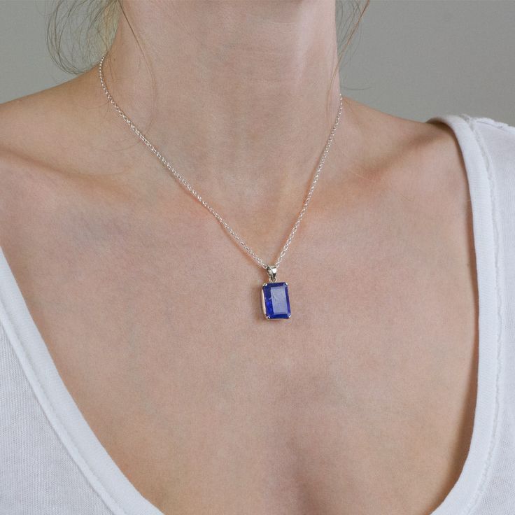 A delicate balance of rich blue and violet, this gem has fine crystal inclusions and an exquisite luster. Wearing this deep blue-hued beauty of a faceted tanzanite necklace will add an elegant touch to any outfit. Known as the ‘stone of magic’ it brings its wearer the confidence to turn ideas into reality. Bringing the “will” to start and enhancing from beginning to end. This stone is also great for Communication and Protection. Stone Origin: ﻿Tanzania Measures Approximately: 16 x 12 mm Material Tanzanite Faceted Necklace For Gift, Gift Tanzanite Faceted Necklace, Sapphire Birthstone Pendant Necklace, Blue Sapphire Birthstone Necklace For Gift, Blue Sapphire Birthstone Necklace Gift, Elegant Blue Crystal Necklace With Gemstone Accents, Tanzanite Birthstone Pendant Jewelry, Sapphire Tanzanite Birthstone Necklaces, Tanzanite Birthstone Pendant