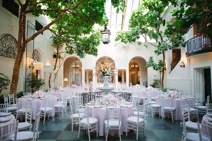 an indoor venue with tables and chairs set up for a formal function in the center