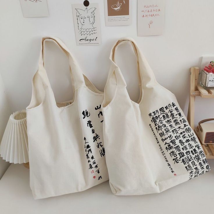 "👉Size: 33x43cm/13\"x17\" Strap: 24cm/ 9.5\" 👉Description  Canvas tote bags adorned with beautiful Chinese calligraphy can use both for men and women, each bag features a sturdy zipper closure, ensuring the safety of your belongings. It also includes an inner pocket ideal for storing your smartphone and other small essentials. The Chinese characters are chosen from the depths of ancient Chinese literature that represent different stories. Whether it's the poetic elegance of Tang Dynasty classics or the philosophical musings of ancient sages, our bags offer a captivating glimpse into the rich literary heritage of China. Our bags not only make a stylish fashion statement but also serve as a window to China's literary treasure trove. They are the embodiment of art, history, and cultural app Square Shoulder Bag With Letter Print For Travel, Square Shoulder Bag With Letter Print For Shopping, Rectangular Shoulder Bag With Letter Print For Shopping, Rectangular Letter Print Shoulder Bag For Shopping, Large Capacity White Rectangular Canvas Bag, Rectangular Satchel For Daily Use, Beige Canvas Satchel Bag For Daily Life, Large Rectangular Canvas Shoulder Bag, Large Square Bag For Daily Use