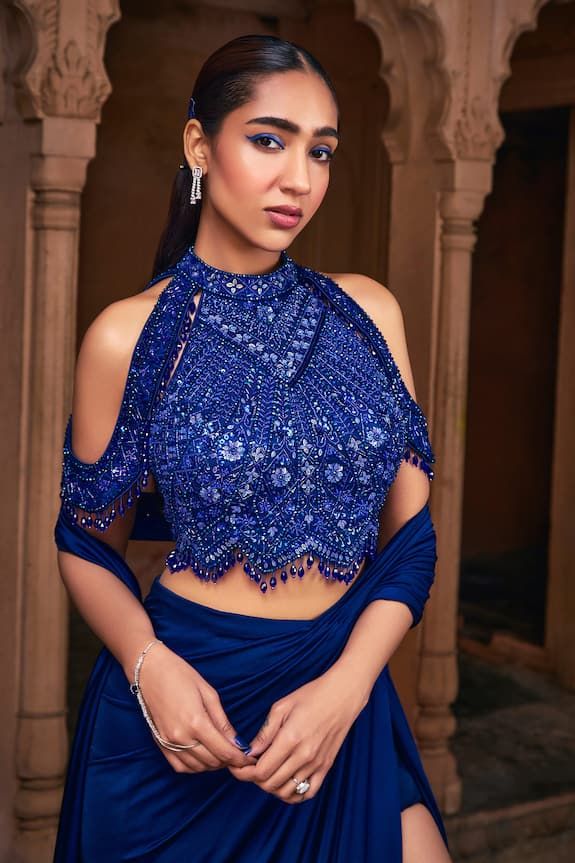 Dark blue pre-draped skirt saree. Paired with a blouse with all over sequins, crystals, beaded embroidery and panel on sleeves. - Aza Fashions Elegant Blue Pre-draped Saree For Navratri, Elegant Blue Top For Wedding, Elegant Evening Blouse Piece For Navratri, Fitted Blue Blouse Piece For Reception, Royal Blue Elegant Festive Blouse Piece, Glamorous Blue Sets For Reception, Elegant Blue Georgette Lehenga, Blue Floor-length Blouse Piece For Evening, Blue Traditional Drape Blouse Piece For Party