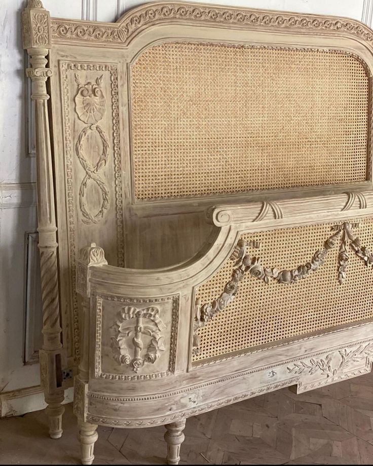 an old white bed with wicker headboard and foot board, in a room