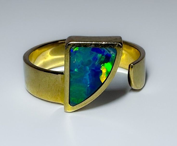 Mid century c1960s This is a fantastic MCM 14k piece with a fantastic Australian black Opal inlay in a unique abstract design. Good sized ring, solid and well made.  The video is so so because, I am waiting for the sun to come out and then I can demonstrate how gorgeous this Opal is. 4.3g 14k solid yellow gold Hallmarked Australian black Opal (possibly solid or an inlay) Face measures 11mm wide The band measure 4.8mm S 7.25 US resizable or adjustable Excellent vintage condition Modern Yellow Gold Collectible Rings, Modern 14k Gold Opal Ring With Polished Finish, Modern Opal Ring In 14k Gold With Polished Finish, Collectible Modern 14k Gold Jewelry, Modern 14k Gold Collectible Jewelry, Unique Yellow Gold Opal Ring With Polished Finish, Unique Hallmarked Opal Ring For Formal Occasions, Modern 14k Gold Opal Ring For Formal Events, Modern 14k Gold Opal Ring For Formal Occasions