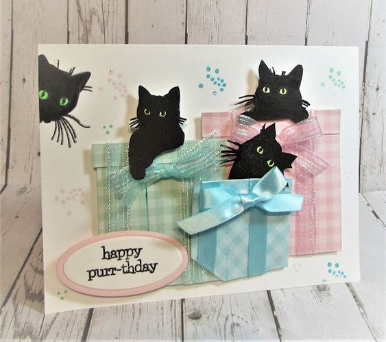 a card with three black cats in a gift box