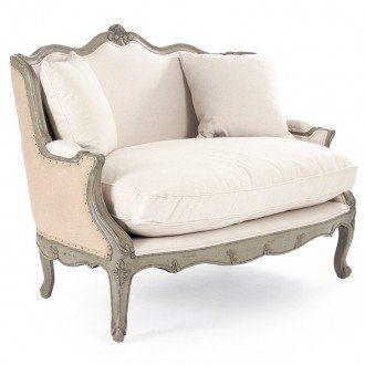 an old fashioned chair with white pillows on it's back and armrests