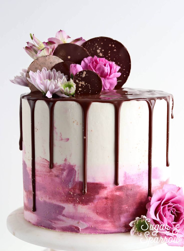 a close up of a cake on a plate with flowers and oreo cookies in the top