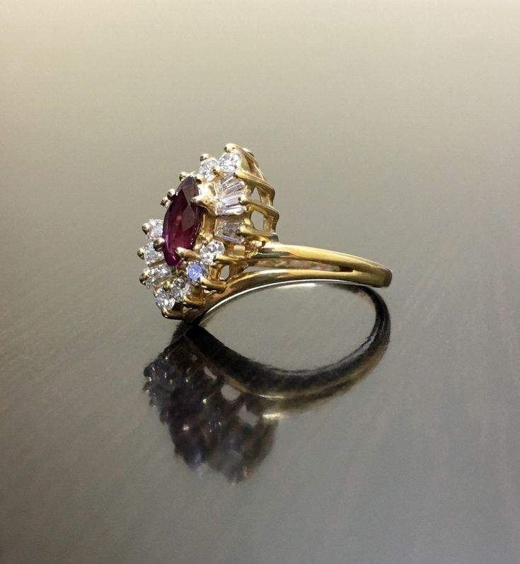 DeKara Designs Classic Metal- 14K Yellow Gold, .583 Stones- 1 Natural Marquise Ruby 0.30 Carats, 6 Baguette Diamonds, 8 Round Diamonds, F-G Color VS2 Clarity. Size- 4. FREE SIZING Art Deco Inspired Handmade Ruby Diamond Engagement Ring, Made in 14K Yellow Gold. The ring features a beautiful prong set marquise ruby. The marquise has three prong set baguette and four round diamonds that are also prong set on each side. This ring is a one of a kind and entirely handmade! FREE SHIPPING 7 Day Return Ruby Diamond Engagement Ring, Gold Ruby Ring, Ruby Diamond Ring, Art Deco Gold, Ruby Ring Gold, Ruby Diamond Rings, Ruby Engagement Ring, Baguette Diamonds, Diamond Wedding Ring