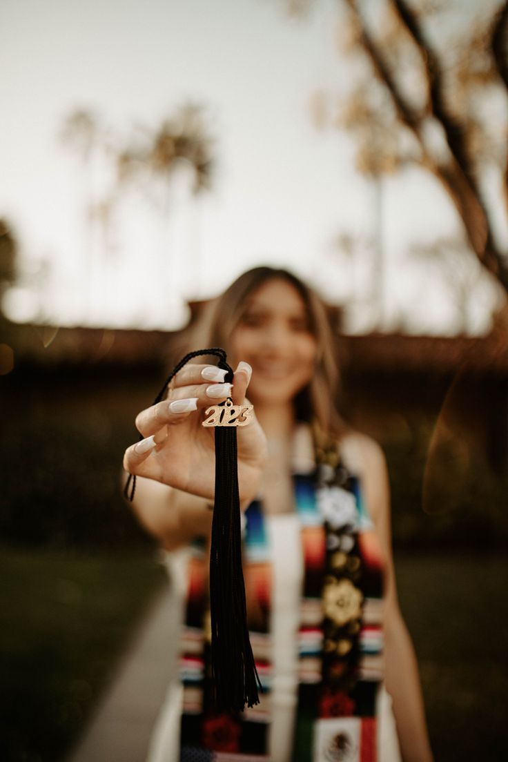 a woman is holding up her name ring