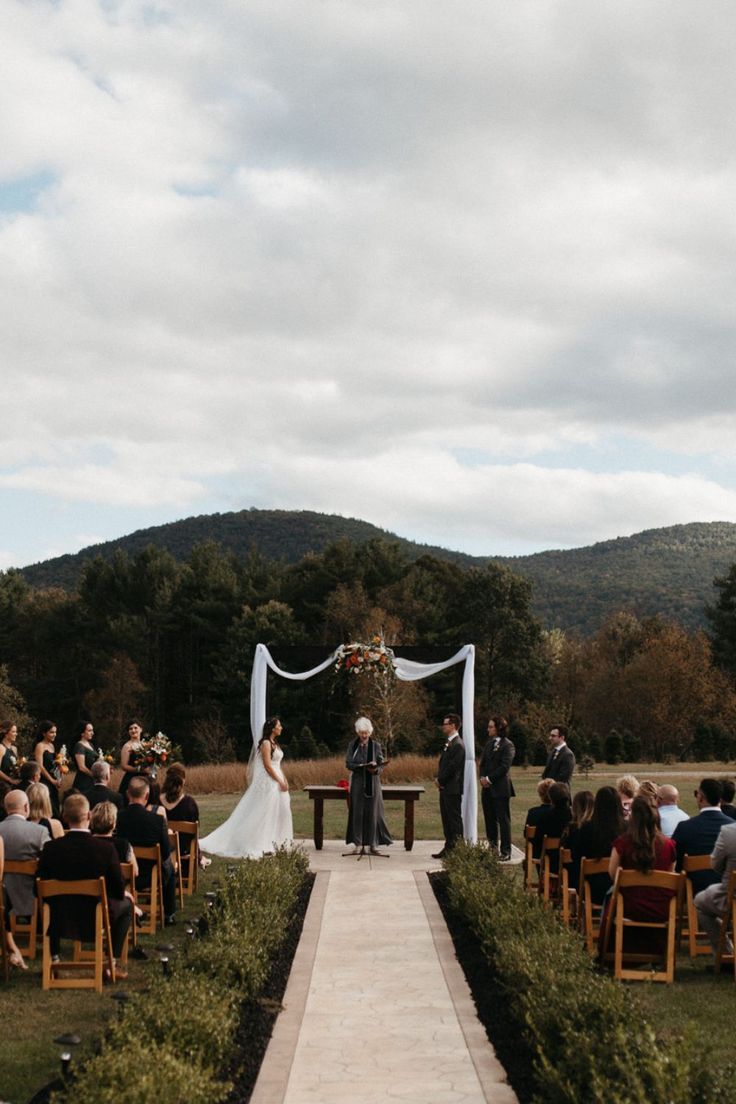 a bride and groom standing at the end of their wedding ceremony