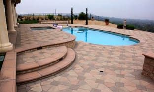 an outdoor swimming pool with steps leading up to it