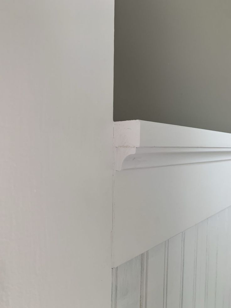 the corner of a room with white paint on it