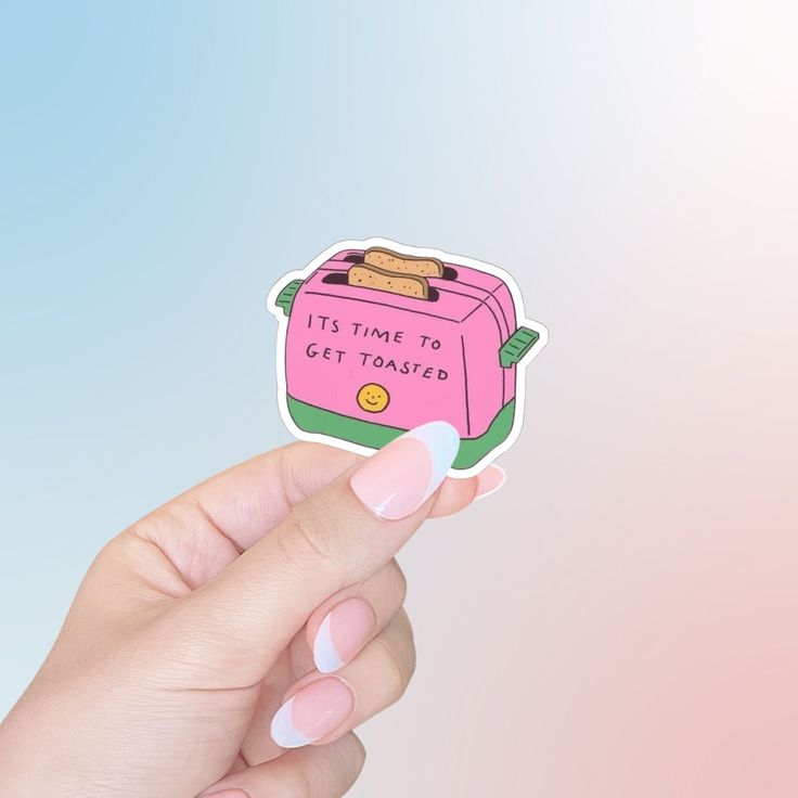 a person holding up a pink sticker with toasters on it's side