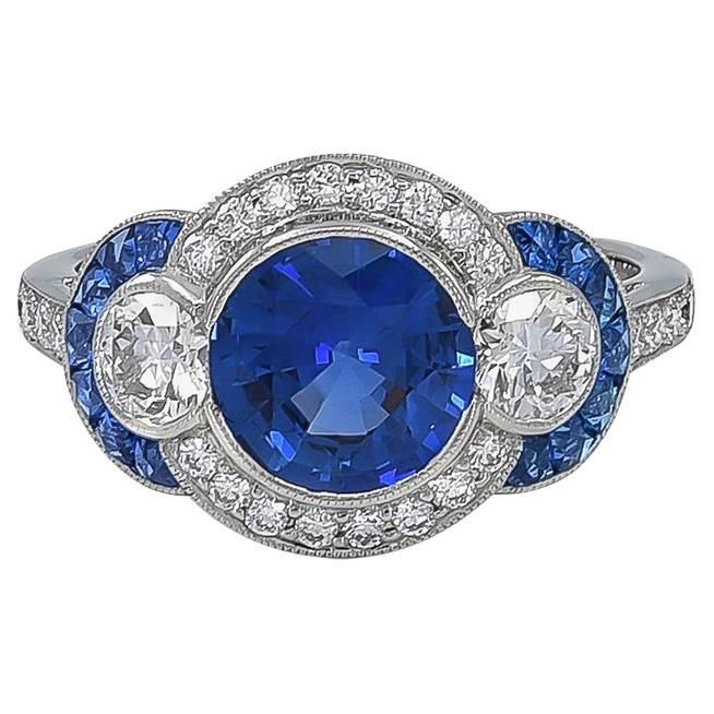 Sophia D platinum ring with an exquisite blue sapphire center weighing a total of 2.00 carat. Encompassing the center are round diamonds with the weight of 0.52 carat, sapphires weighing 0.40 carats and diamonds with the weight of 0.24 carat. Ring is 6.5 and available for resizing. Sophia D by Joseph Dardashti LTD has been known worldwide for 35 years and are inspired by classic Art Deco design that merges with modern manufacturing techniques. Royal Blue Sapphire Ring With Brilliant Cut, Royal Blue Brilliant Cut Sapphire Ring, Classic Blue Diamond Ring, Luxury Royal Blue Sapphire Round Ring, Classic Blue Halo Ring, Classic Blue Sapphire Diamond Ring, Platinum Blue Sapphire Gemstone Ring, Blue Sapphire Gemstone Ring In Platinum, Classic Blue Brilliant Cut Diamond Ring