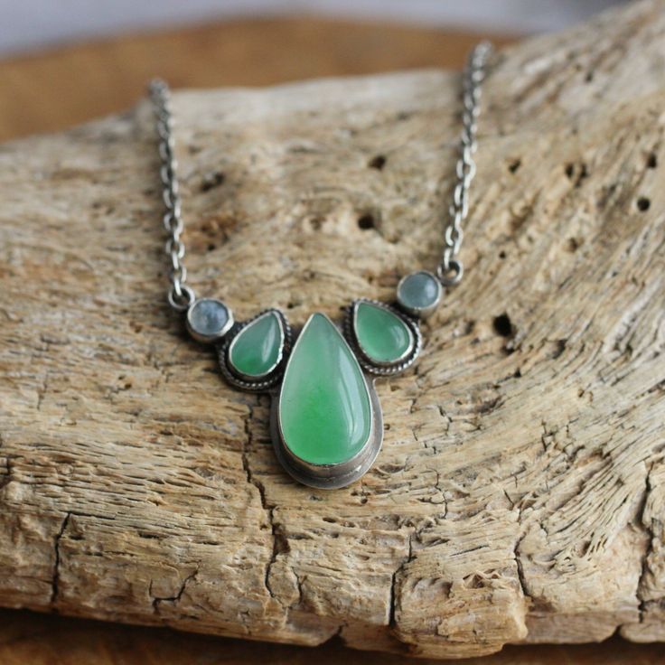 Welcome the Harmony Necklace, our new Multi-stone Jade Necklace with Aquamarine. We love the harmony between the stones - in color and in hue and temperature. A glorious focal of beautiful grass green Burma Jade and aquamarine with our favorite, hefty, .925 Sterling Silver chain - smooth, oxidized, sanded and polished for ultimate comfort. A nice western take on some not-so-western stones. Here, we love color of all types -- and quality, bright green Jade is second to none. A timeless piece! All Green Pendant Necklace With Stones, Green Gemstone Teardrop Pendant Necklace, Green Teardrop Pendant Necklace With Gemstone, Nature-inspired Jade Gemstone Necklaces, Nature-inspired Jade Gemstone Necklace, Nature-inspired Green Jade Necklaces, Green Pendant Necklaces With Gemstone Accents, Unique Green Natural Stone Necklace, Green Gemstone Pendant Necklace