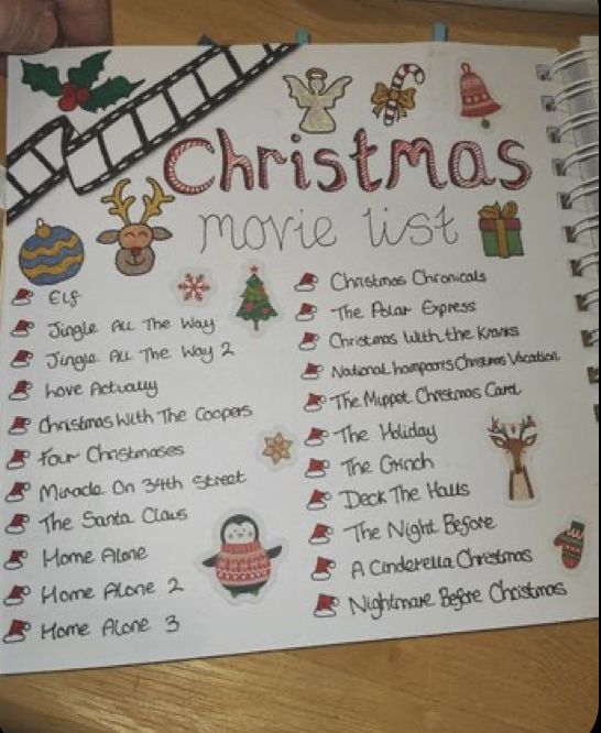 a christmas movie list is displayed on a table