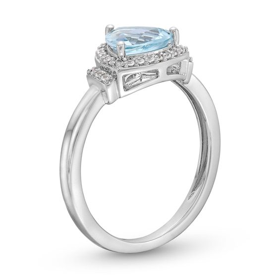 a white gold ring with an oval aqua blue topazte and diamonds on the sides