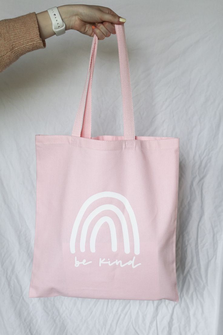 "This adorable tote bag features a hand lettered quote reading \"be kind.\" It's the perfect go-to reusable tote! PRODUCT DETAILS: -dimensions - 14\" x 16\" -colors available - natural and light pink -100% heavy cotton canvas -all designs are created by oriJENal Creations Questions?? Want a custom piece?? Please don't hesitate to contact me!" Tote Bag Quotes, Handpainted Tote Bags, Canvas Bag Design, Quote Tote Bag, Pink Tote Bag, Bag Quotes, Funny Tote Bags, Diy Bag Designs, Painted Tote