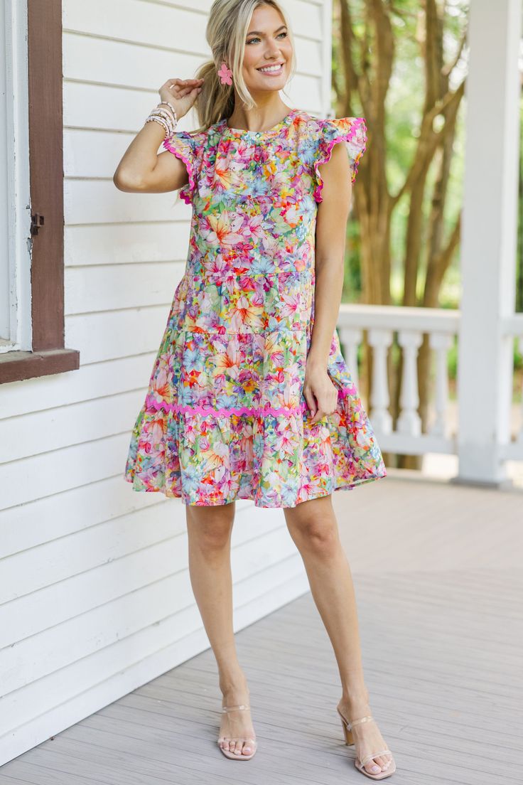 Say hello to this colorful floral babydoll dress with its charming rickrack detailing! Bursting with stunning colors, this dress is sure to brighten your day. The ruffled cap sleeves add a touch of femininity, making it perfect for any occasion. Pair it with sneakers for a fun day out or dress it up with heels for a chic, sophisticated look! Round neckline Button keyhole back Ruffled cap sleeves Colorful floral print Rickrack detailing Babydoll cut No stretch Baileigh is wearing the small. Playful Ruffle Sleeve Dress With Floral Print, Playful Floral Print Dress With Ruffle Sleeves, Playful Ruffled Floral Dress For Spring, Multicolor Short-sleeve Floral Dress With Ruffles, Multicolor Floral Dress With Ruffles And Short Sleeves, Playful Multicolor Floral Dress For Spring, Multicolor Flutter Sleeve Dress With Ruffle Hem, Multicolor Flowy Ruffle Sleeve Dress, Multicolor Flowy Dress With Ruffle Sleeves