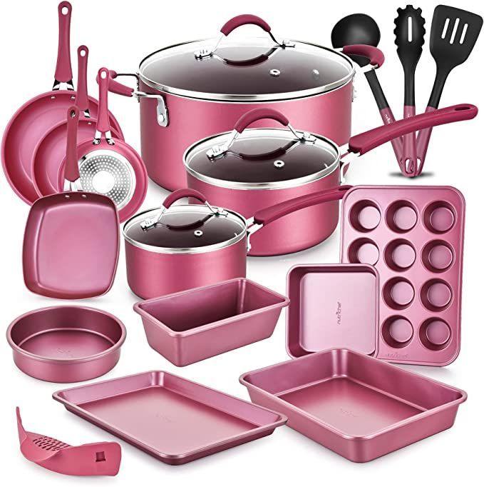 an assortment of pink kitchenware including pots, pans and utensils