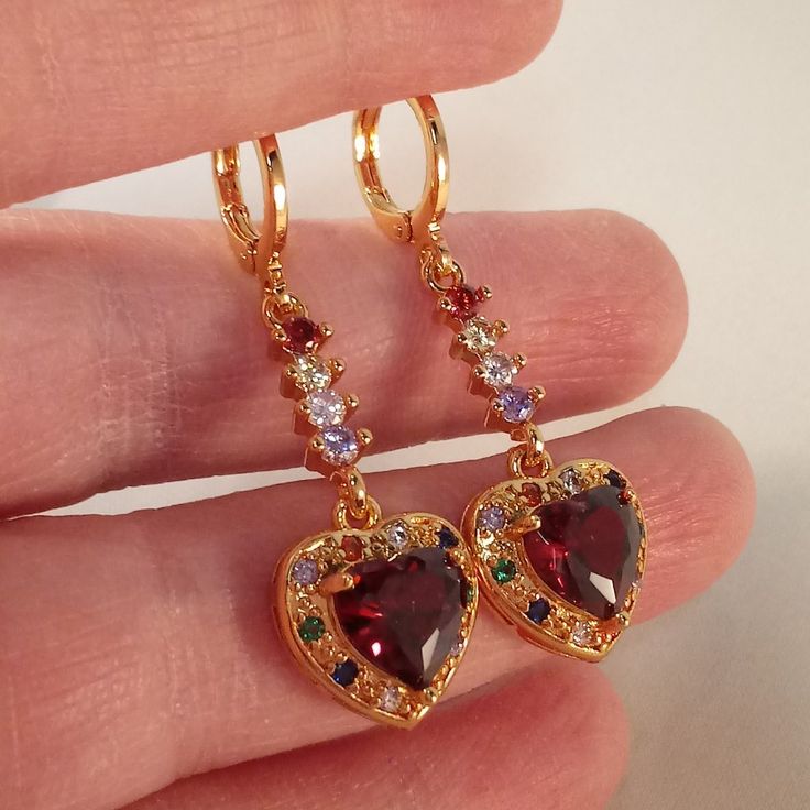 Colorful Gemstone Jewelry, Ruby Gold Jewellery, Dangling Gold Earrings, Red Heart Pendant Earrings For Anniversary, Red Heart-shaped Cubic Zirconia Earrings, Red Heart Cut Elegant Earrings, Elegant Red Heart Cut Earrings, Valentine's Day Cubic Zirconia Dangle Heart Earrings, Valentine's Day Cubic Zirconia Heart Dangle Earrings