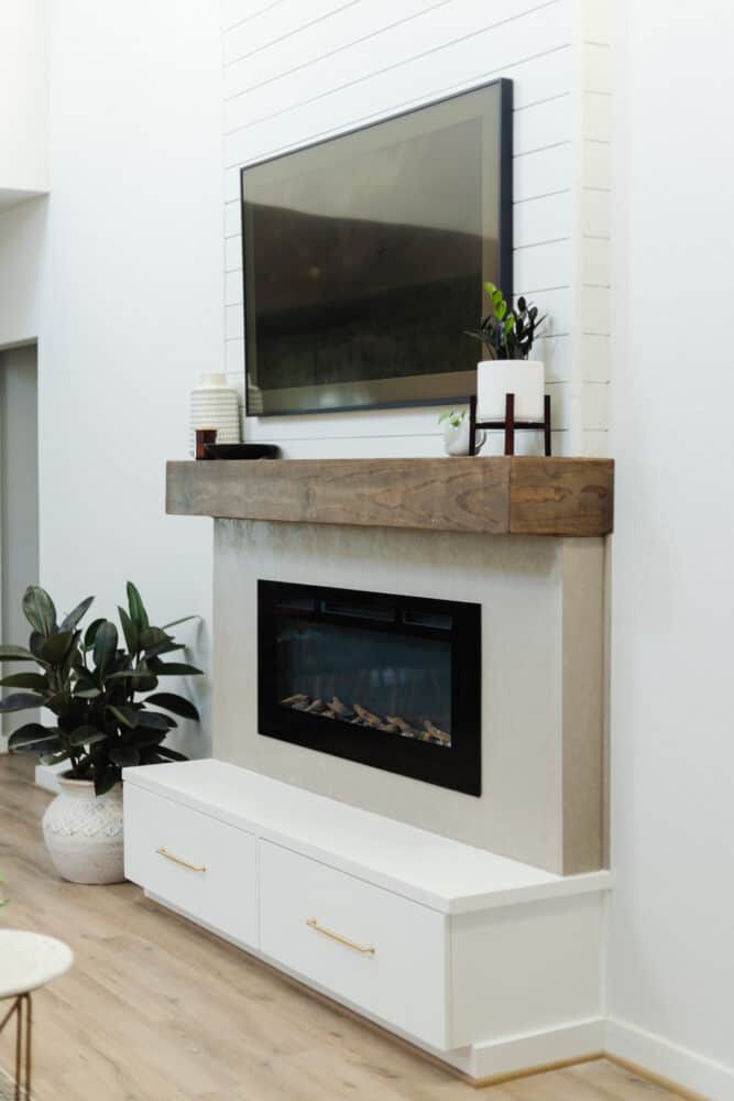 a fireplace with a flat screen tv mounted on it's wall above the mantle