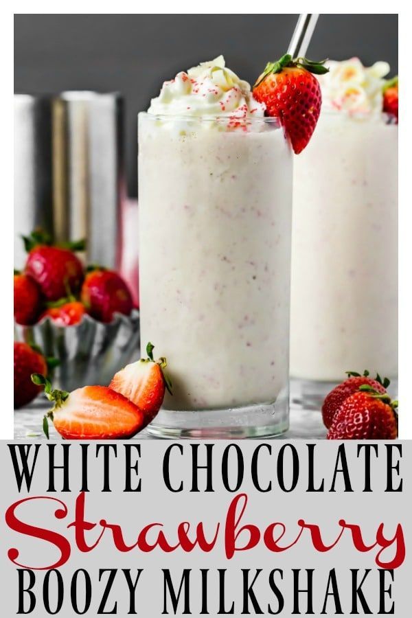 two white chocolate strawberry boozy milkshakes with strawberries